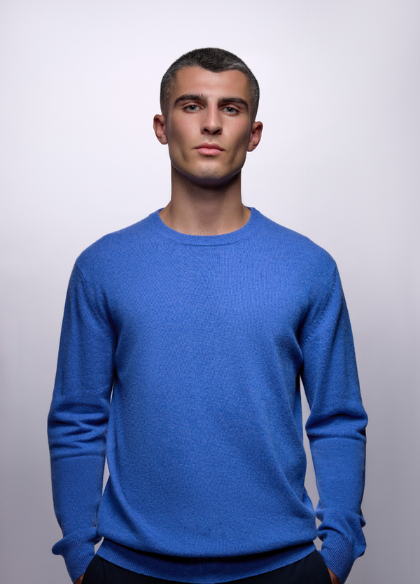 Denner men's crew neck cashmere jumper in Carolina blue, front view on model